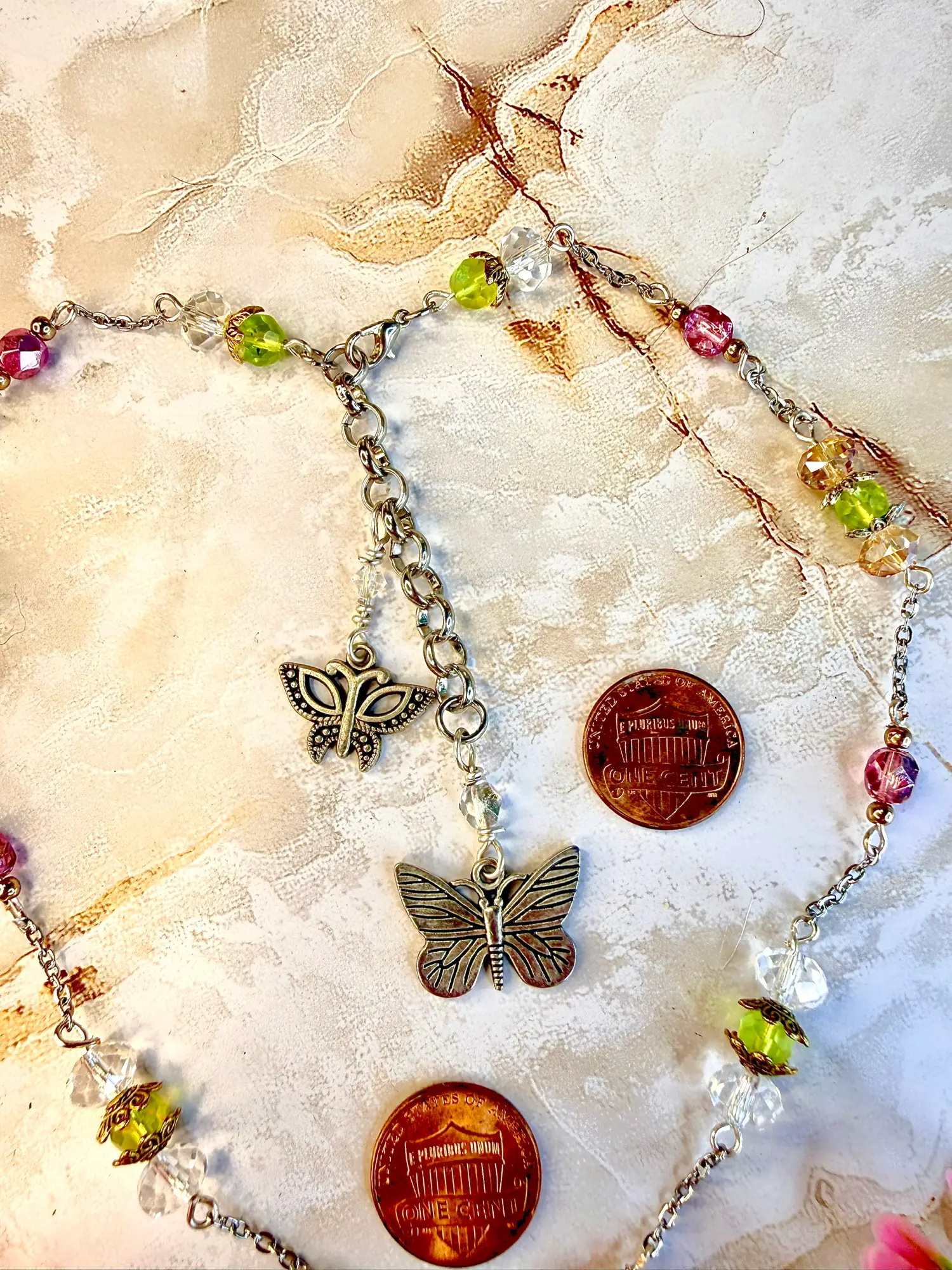 Shimmering turquois heart pendant's extension chain. Two silver butterfly charms dangling on a 3" silver chain