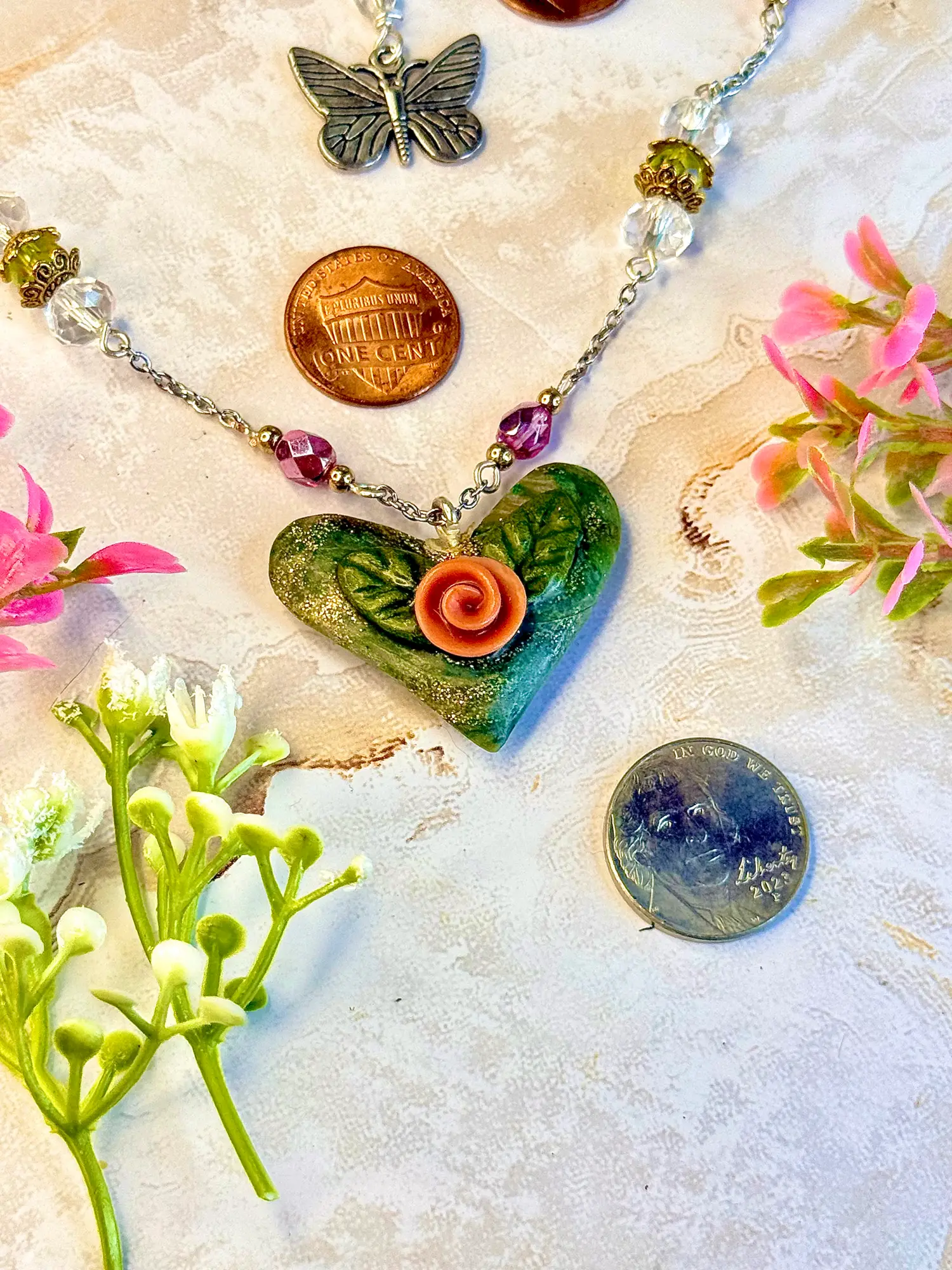 Heart Pendant -- shimmering turquoise and a big coral flower, made with polymer clay. Alternating pink and green preciosa beads make for a whimsical, yet high end piece.