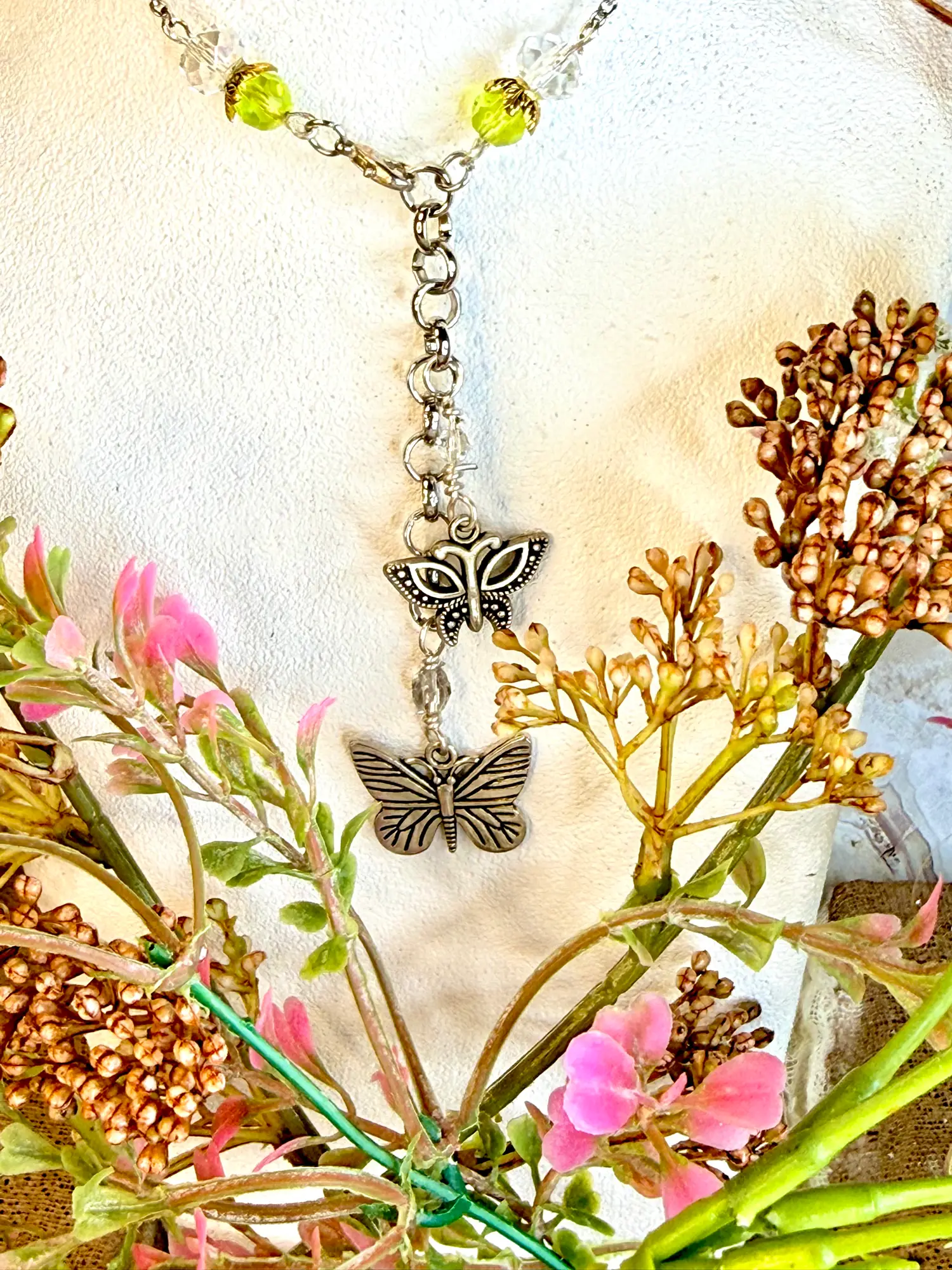 Shimmering turquois heart pendant's extension chain. Two silver butterfly charms dangling on a 3" silver chain